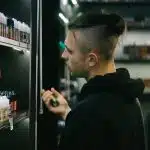 a man is looking at a display of hair products