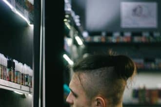 a man is looking at a display of hair products