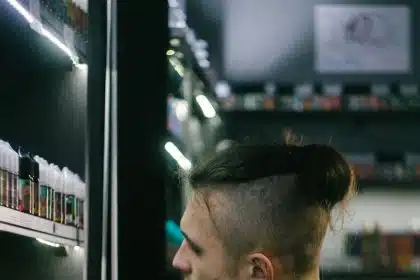 a man is looking at a display of hair products