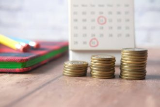 pièces de monnaie et calendrier sur un fond en bois